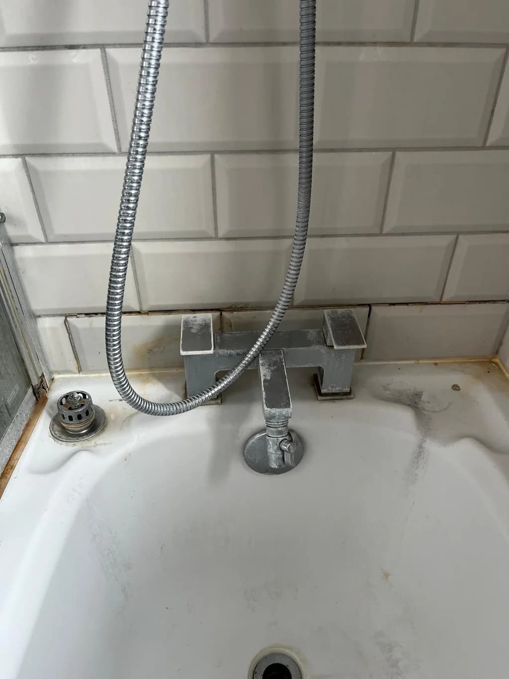 Bath mixer taps coated in limescale and grime before cleaning