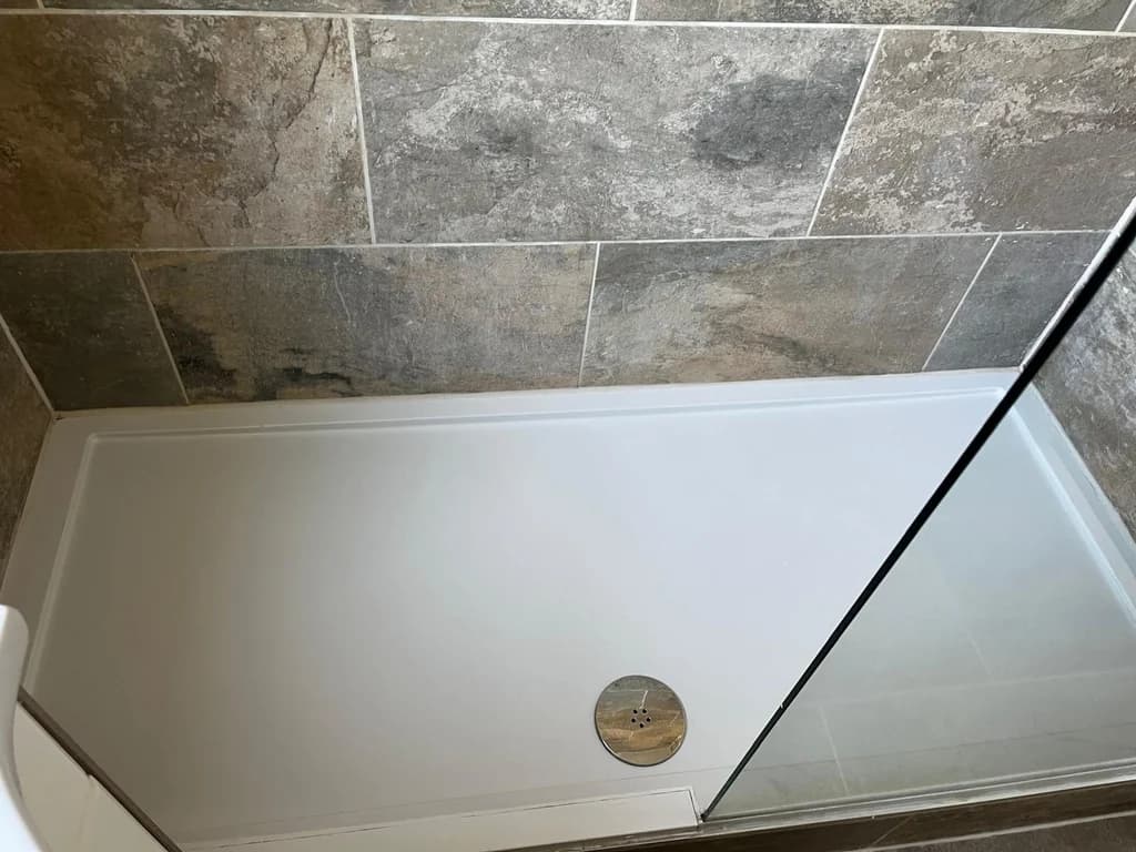 Shower tray restored to bright white after descaling