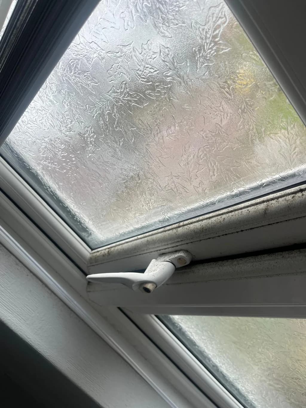 Bathroom window frame with black mould before cleaning
